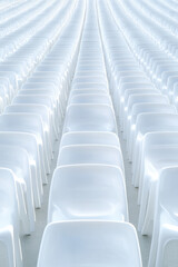 Empty plastic rows of seats in an outdoor stadium, waiting for a match, preparing a fan zone