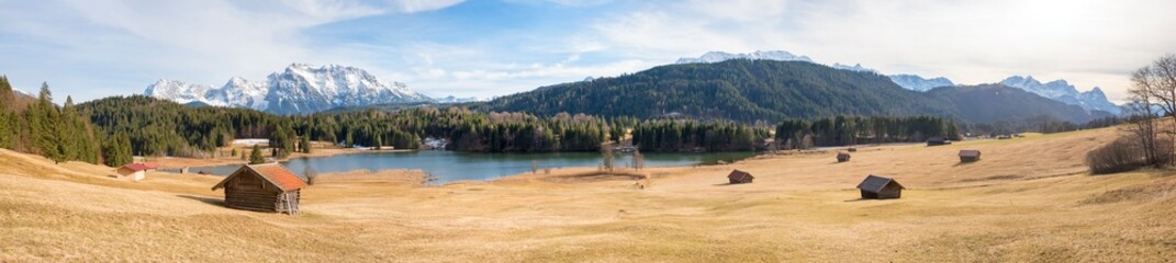 wide panorama landscape lake Geroldsee, meadow with huts, view to Wetterstein and Karwendel...
