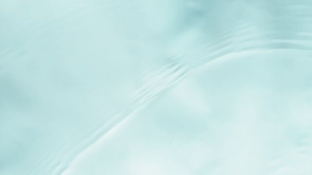 Slow motion of splashing water on light blue background , filmed on high speed cinematic camera at 1000 FPS