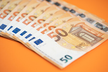 50 euro bills on an orange background
