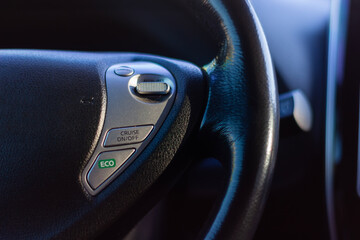 Steering wheel controls showcase eco mode and cruise function in modern vehicle design