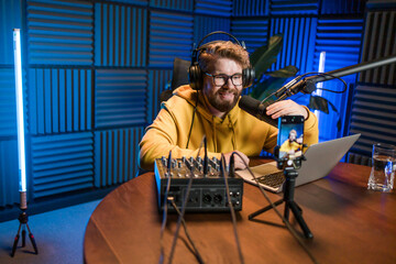 Handsome man radio DJ hosting a radio show, entertainment and communication concept
