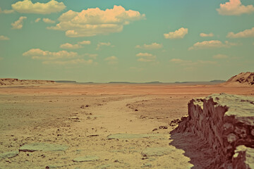Endless Desert vista under Blue Sky: A vast expanse of arid landscape stretches towards the horizon, where the earth meets a vibrant blue sky adorned with fluffy clouds, evoking feelings of solitude.