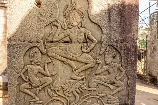 Ancient Bayon ruined temple walls decorated with dancing apsaras statues, Angkor Archaeological Park, Siem Reap, Cambodia