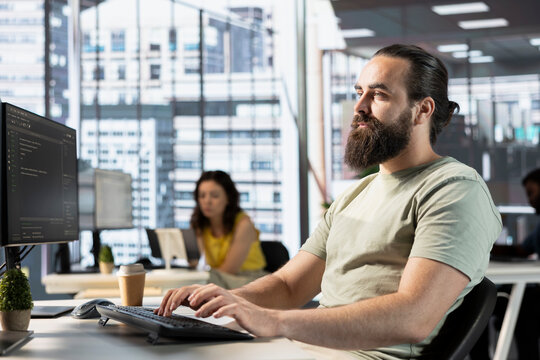 Data scientist doing software quality assurance, reading source code on computer before implementing it. IT employee in office inspecting coding on PC device, looking to fix potential issues
