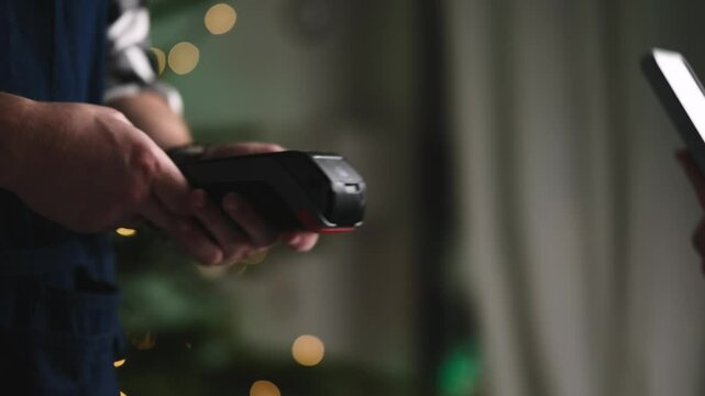 Girl Using Smartphone For A Wireless Bill Payment In A Restaurant During Christmas