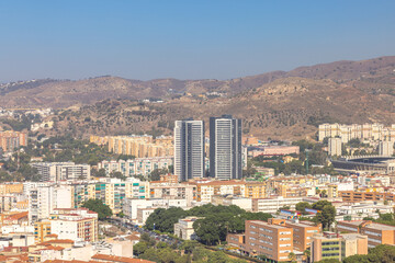Malaga, seaside city in Andalusia, Spain, Europe. Cityscape view with high-rise buildings and mountains in the background.