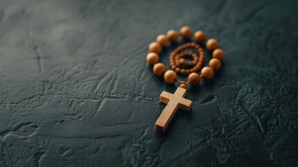 A beautiful wooden rosary with beads and a cross, symbolizing faith and devotion, resting on black leather.