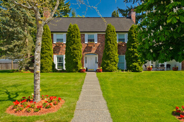 Two story luxury house with beautiful summer  landscape in Vancouver, Canada, North America. Day time on June 2024.