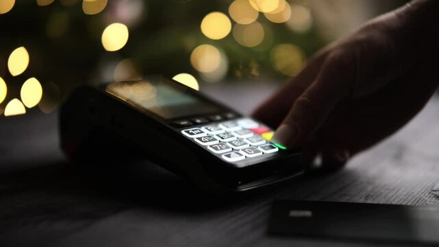 Girl Entering Amount Or Pin Code On Wireless Terminal At Counter At Christmas