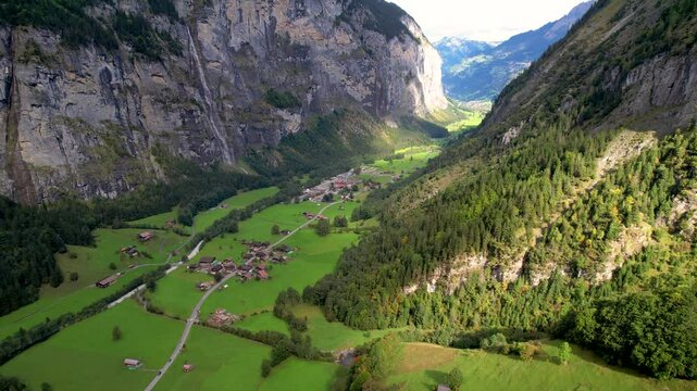 Beautiful aerial footage of Lauterbrunnen, a Swiss Alps valley with stunning cliffs, Staubbach and Tr&uuml;mmelbach Falls. A cable car from Stechelberg leads to Schilthorn, offering breathtaking views.
