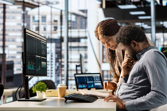 African american CEO and employee review company numbers, creating a roadmap that includes goals, strategies and resource allocation management. Specialists meet corporate objectives.