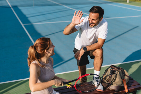 Young couple playing tennis outdoors enjoying a fun summer game