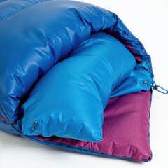 Blue sleeping bag tightly rolled, showcasing durable fabric, ripstop, packed, robust