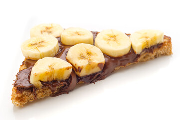 Delicious slice of bread with chocolate spread and fresh banana slices displayed on white background
