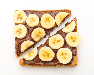Delicious banana and chocolate spread on toasted bread served as a quick snack