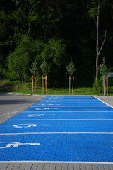 Large disabled car park marked in bright blue and with a special marking.
