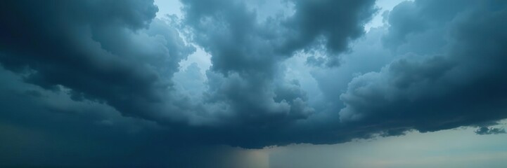 Heavy grey storm clouds with dark blue undertones in a vast sky, grey, thunderstorm, cloudy