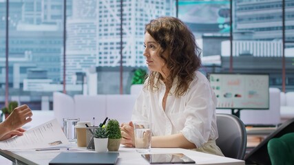 In a professional interview setting, job seeker presents detailed CV to an HR recruiter....