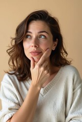 Pensive young woman reflecting with finger on chin