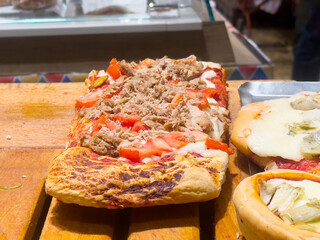 Delicious freshly baked focaccia with pulled pork and tomato topping
