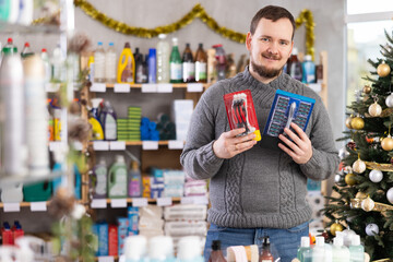 On Christmas Eve, man gets acquainted with assortment, choose razor, shaver, new products. Client...
