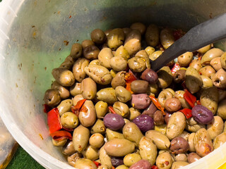 Mixed olives with red peppers in bowl