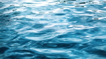 Fototapeta premium A close-up view of shimmering blue water, showcasing its gentle waves and reflections, evoking a sense of calmness and tranquility.