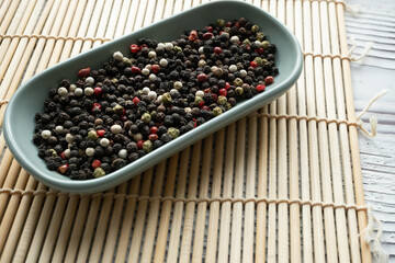 black pepper in a blue spoon