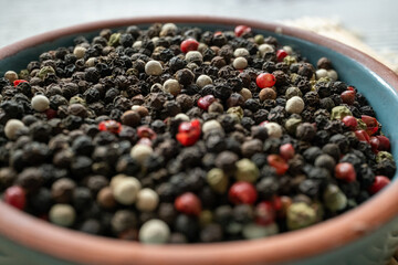 black pepper in a wooden bowl macro shot