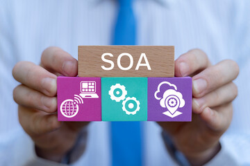 SOA Service Oriented Architecture Business Technology Concept. Business person holding blocks with icons sees abbreviation: SOA.