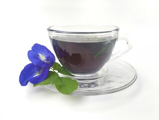 Boiled butterfly pea flower water in a glass on white background 