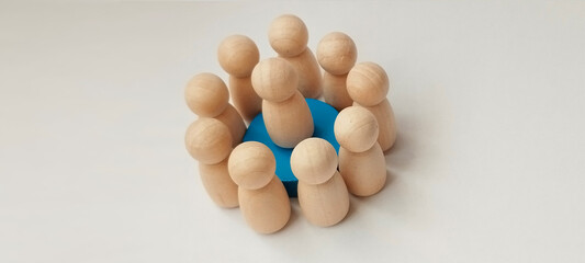 Group collaboration among wooden figures minimalist setting conceptual art neutral background top view team dynamics