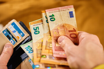 Wallet with euro banknotes and credit cards. Close up of purse with cash money. Concept of personal...