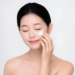 A young woman applying skincare products, showcasing a beauty and self-care routine for healthy, glowing skin.