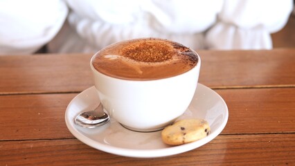 Captivating latte art on frothy cappuccino Coffee culture meets artistry in warm caft setting where skilled barista crafts intricate design on velvety foam elevating experience Coffee theme concept