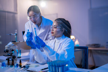 Two women in lab coats are working on a project