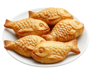 Delicious fish shaped pastries on white plate, perfect for sharing. These treats are golden brown and have textured surface, making them visually appealing and appetizing