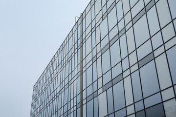 Modern building with many windows against blue sky