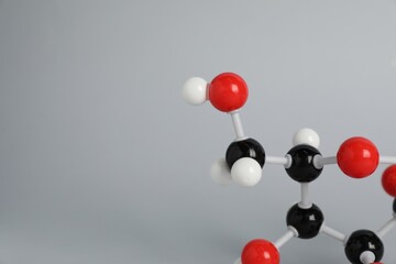 Molecule of glucose on light grey background, closeup and space for text. Chemical model