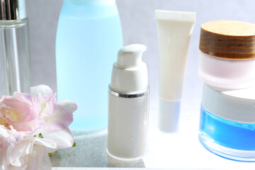 Presentation of body care products on glass surface, closeup