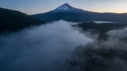 Misty morning view of Mount Hood, Oregon. Dense fog blankets the valley below. Epic landscape. Mt Hood, Trillium Lake, Oregon, United States