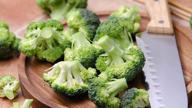 pile of green broccoli on cutting board - close up