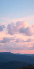 Obraz premium Fluffy Clouds in Soft Gradient Hues Stretch Across the Sky, Creating a Peaceful Evening Scene