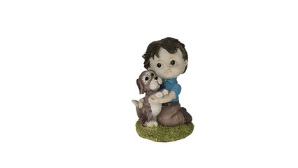 A figurine of a young boy kneeling and hugging a small dog isolated against a white background