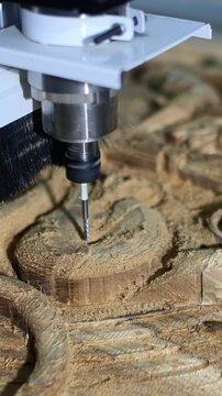 carving a stylized teak collage on a CNC machine with a 4 mm diameter cutter, a ship figurine, marine animals, the final stage