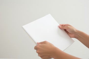 Obraz premium Hands holding blank paper indoor setting minimalism neutral colors