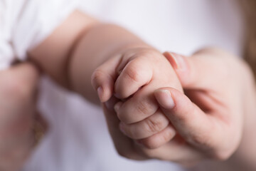 Little newborn baby hands and fingers delicate close up