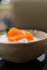 Sliced salmon sashimi served on ice. Japanese raw food delicious menu. Selective focus