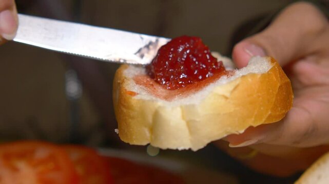 Preparing a delicious slice of bread with jam